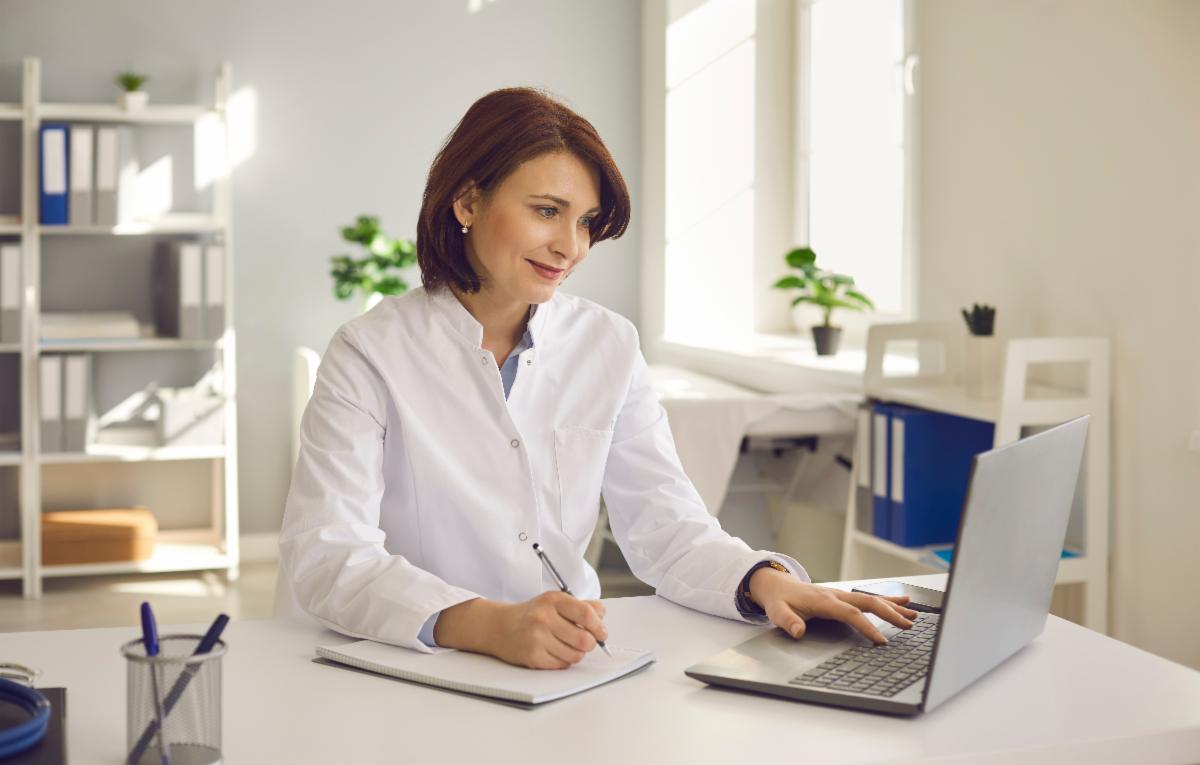 A woman working on her computer in an office space.