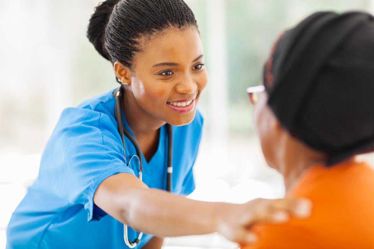 Physician placing hand on patient's shoulder