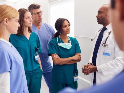 group of healthcare providers talking in hallway