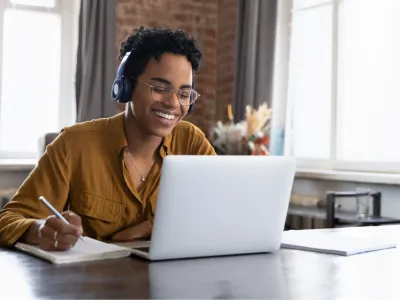 Woman with headphone using laptop