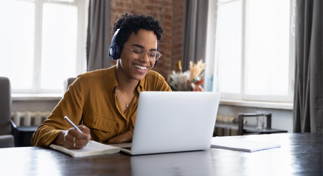 Woman with headphone using laptop